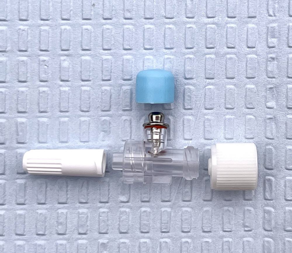 Johan adapter used to deliver electrical stimulation via epidural catheter with hub guards removed.