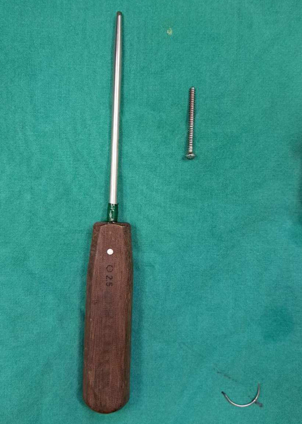 The screw and the medical screwdriver that was used for the removal.